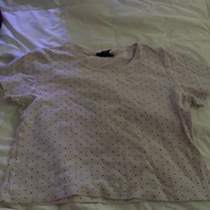 A light baby pink short sleeved, polkadot crop top.